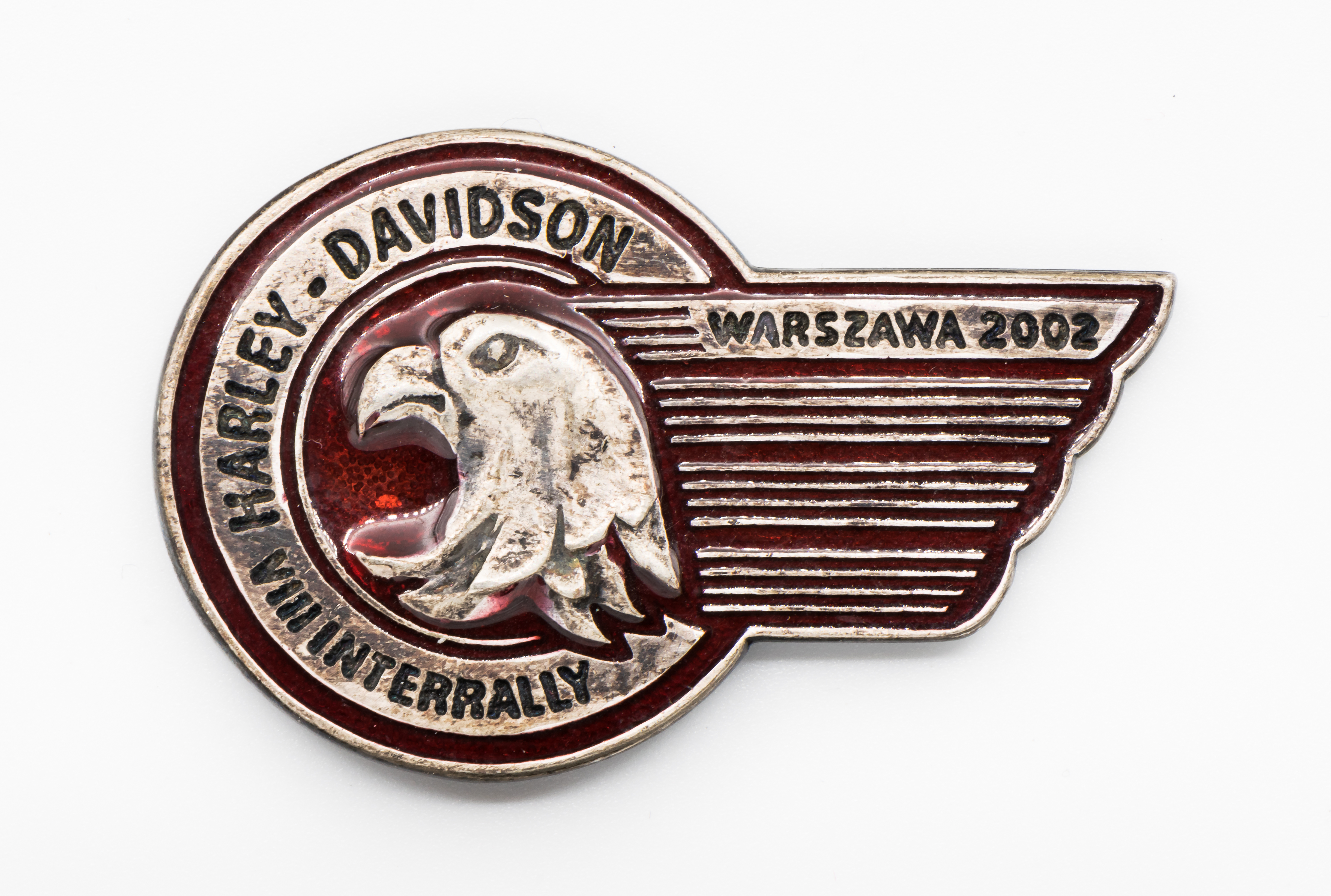 Detailed brass commemorative breast pin from the eighth Harley-Davidson Interrally held in Warsaw, Poland in 2002. Same uploader as the membership badge on the previous image, showing the regalia tradition across decades.