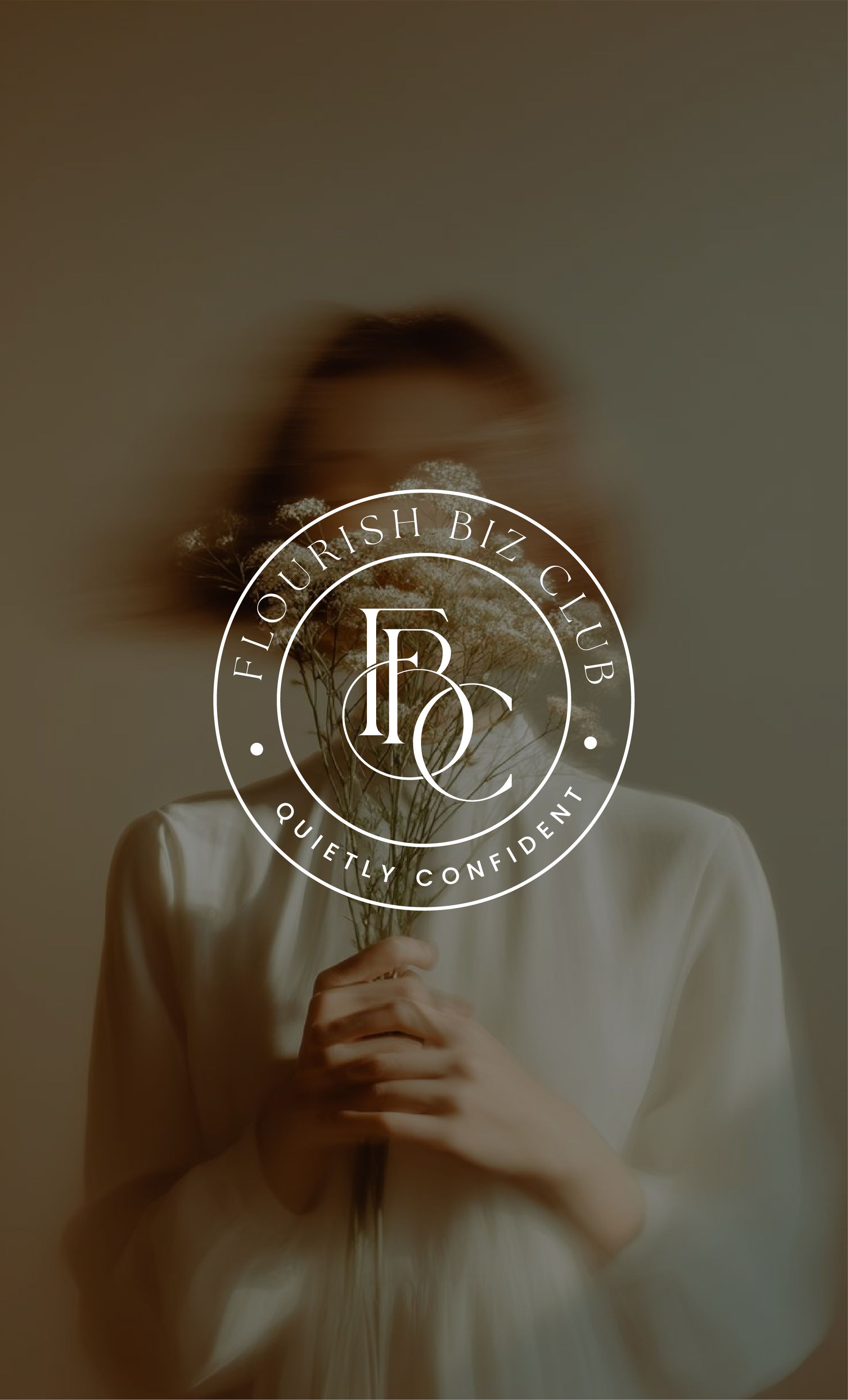 Person in white shirt holding dried flowers with "Flourish Biz Club - Quietly Confident" circular logo overlay