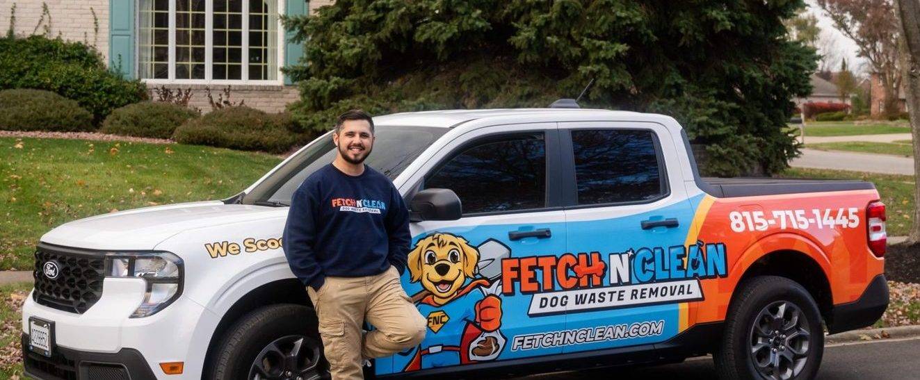 A Fetch N Clean team member beside the company truck