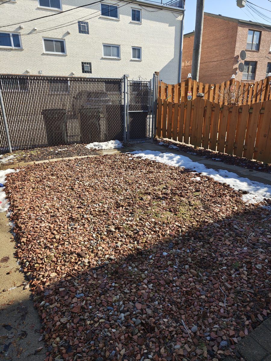 A cleaned mulch yard between two fences