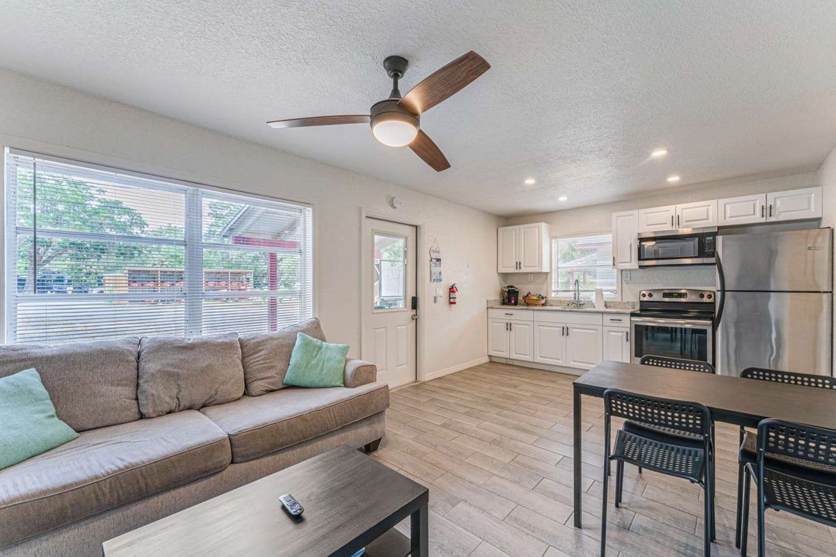 The living room and full kitchen of a one-bedroom cabin